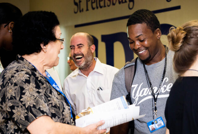 A crowd full of smiles and talking.
